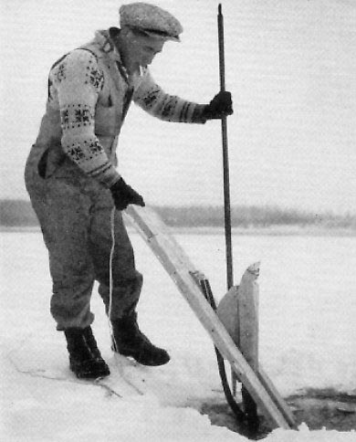 Putting Jigger under the ice. Photo from Web attempting to trace source. Man is wearing an 